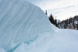 Snow wall on the roadside in an alpine scenery