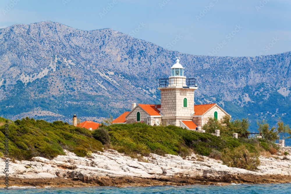The Sucuraj Lighthouse. It is located on the easternmost point of the island of Hvar in Croatia. View of lighthouse from yacht. Holiday in Croatia. Ship transportation.