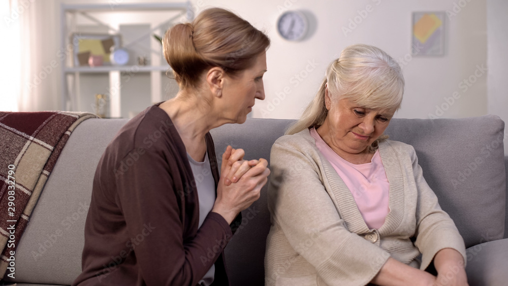 Obraz premium Aged lady feeling sorry for depressed female friend supporting life crisis, care