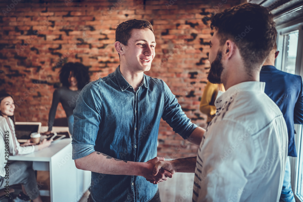 Fototapeta premium two businessmen shaking hands in office
