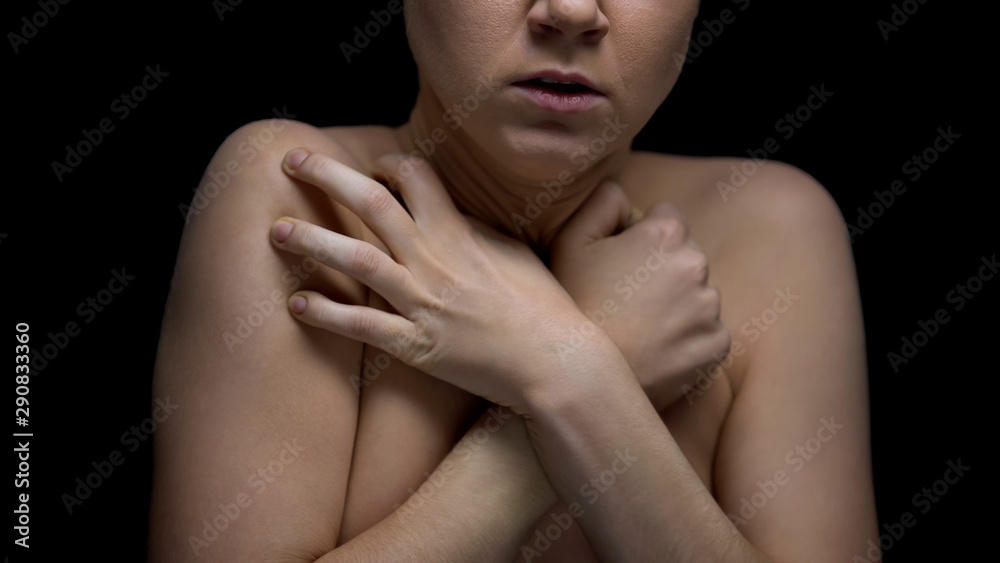 Frightened naked lady with hands crossed turned to camera, scared victim Frightened naked lady with hands crossed turned to camera, scared victim