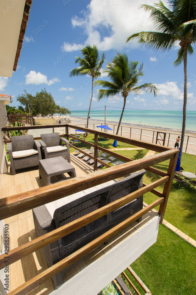 Fototapeta premium Ilha de Itamaraca, Brazil - Circa December 2018: Balcony and view to a turquoise sea from a luxury condominium by the beach