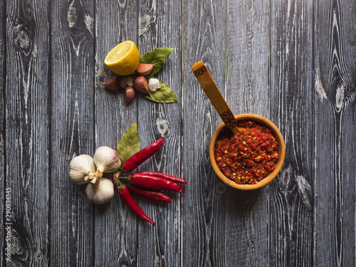 Fototapeta Naklejka Na Ścianę i Meble -  Homemade hot adjika from hot peppers with spices. Top view. 