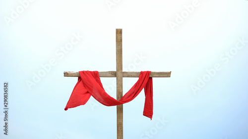 Wooden cross with red cloth wrapped around, crucifix and resurrection of Jesus
