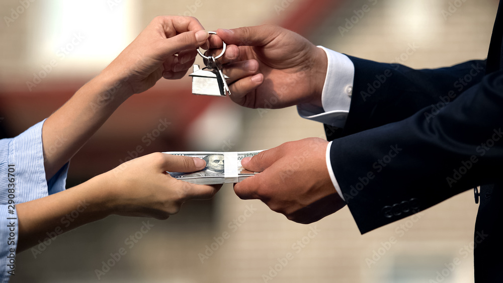 © motortion - Woman and male broker exchanging dollars on keys from apartment, rent, mortgage © motortion - Woman and male broker exchanging dollars on keys from apartment, rent, mortgage