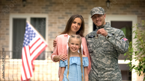 US military man with family showing keys from house, benefits in crediting