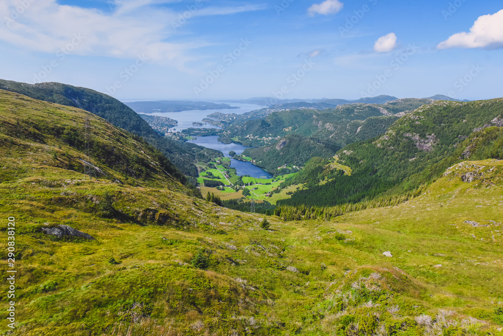 Naklejka premium tourist hiking on a sunny summer day on the nature of mountain norway