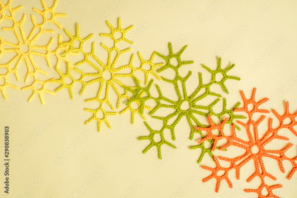 Yellow and orange and red autumn snowflakes knitted on a yellow background. Handmade and creativity. Beautiful background. Autumn card Yellow and orange and red autumn snowflakes knitted on a yellow background. Handmade and creativity. Beautiful background. Autumn card