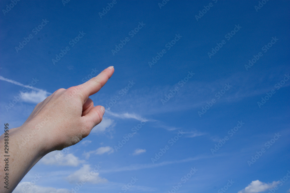 Pointing into blue sky with a few clouds Pointing into blue sky with a few clouds