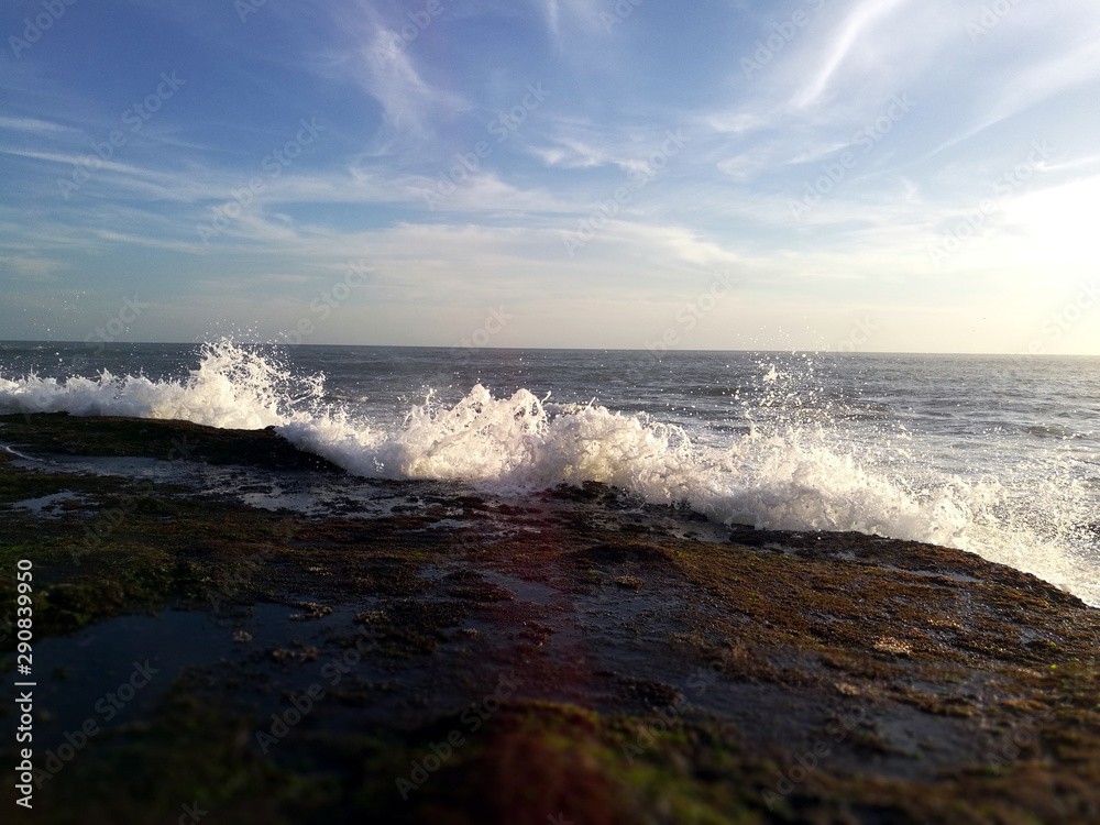 Waves reaching the rocky coast of Bali, Indonesia