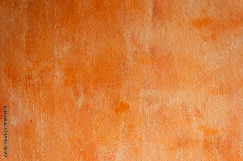 Orange painted wall. Textured paint on the wall.