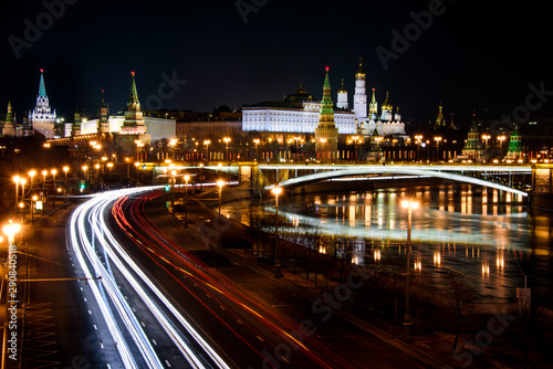 Moscow's Kremlin by night with light trails of cars in the street on the embankment of the Moskva river
