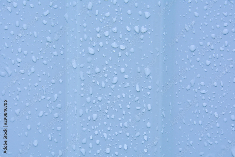 Water drops after rain on a corrugated profile roofing sheet. Abstract background image texture.