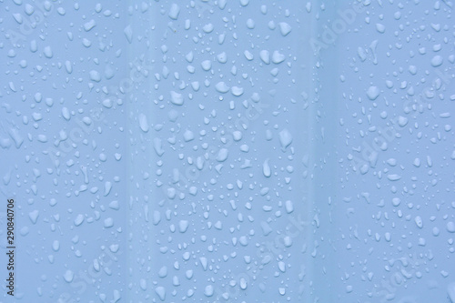 Water drops after rain on a corrugated profile roofing sheet. Abstract background image texture.