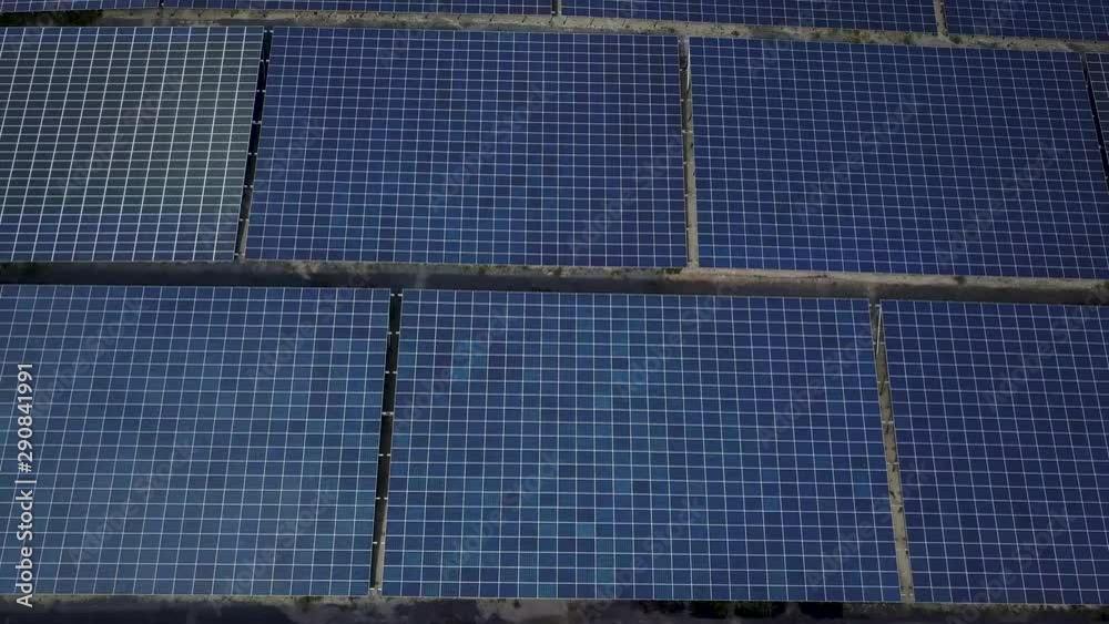 Solar panel farm, alternative green eco-friendly energy. Panels rows along the dry lands. Huge Photovoltaic from an aerial drone point. Top view. Solar panel farm, alternative green eco-friendly energy. Panels rows along the dry lands. Huge Photovoltaic from an aerial drone point. Top view.
