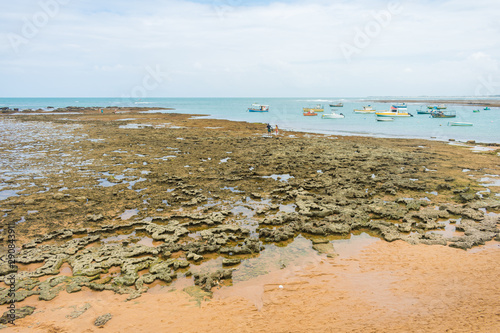 Praia do Forte, Brazil - Circa September 2019: Rocky reefs showing during low tide at Praia do Forte - popular beach near Salvador, Bahia photo