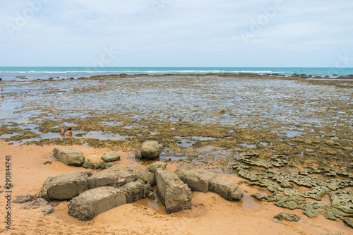 Praia do Forte, Brazil - Circa September 2019: Rocky reefs showing during low tide at Praia do Forte - popular beach near Salvador, Bahia photo