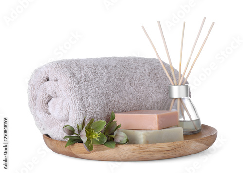 Tray with towel, air freshener and soap bars isolated on white. Spa treatment