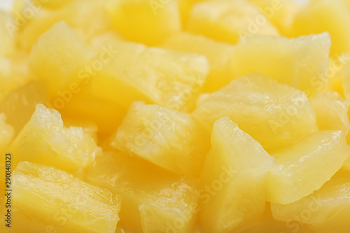 Pieces of delicious sweet canned pineapple as background  closeup