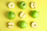 Flat lay composition of fresh ripe green apples on yellow background