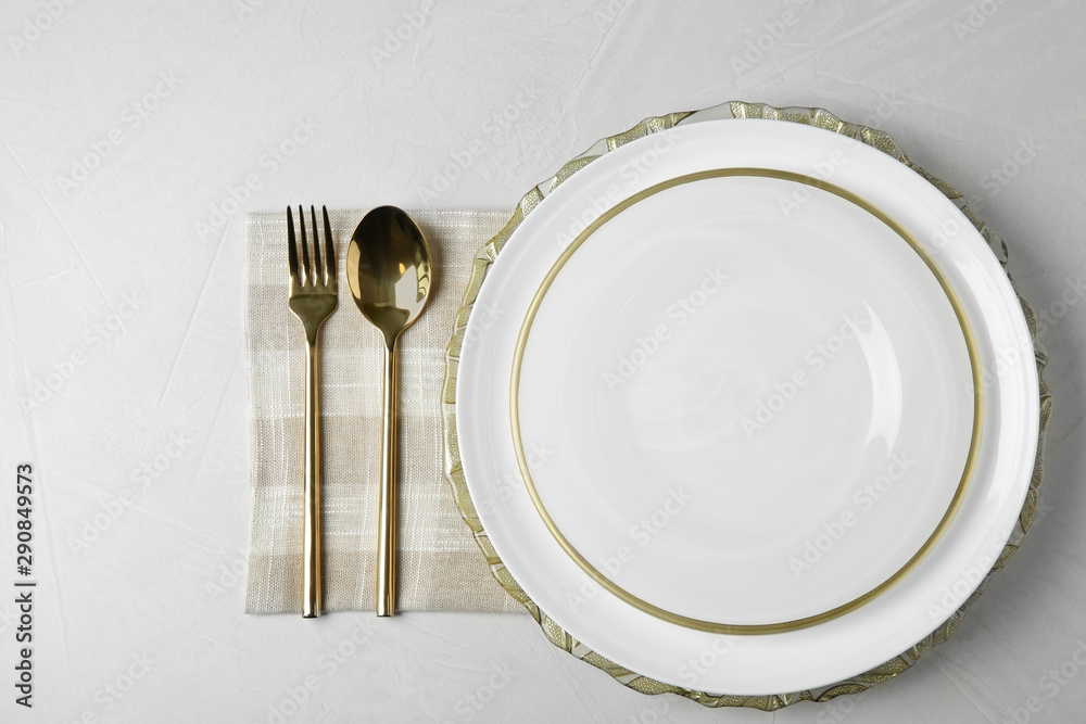 Beautiful table setting on grey background, top view