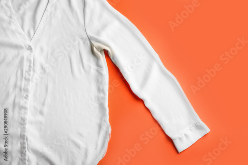 Shirt with deodorant stain on coral background, top view © New Africa