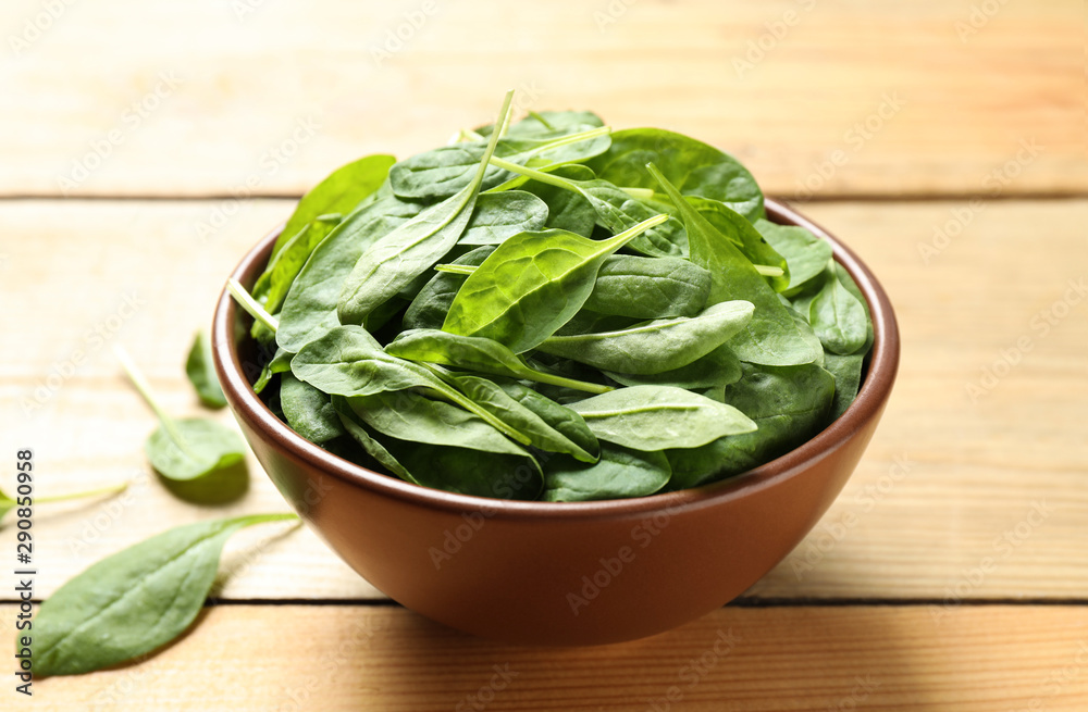 Fresh green healthy spinach on wooden table Fresh green healthy spinach on wooden table