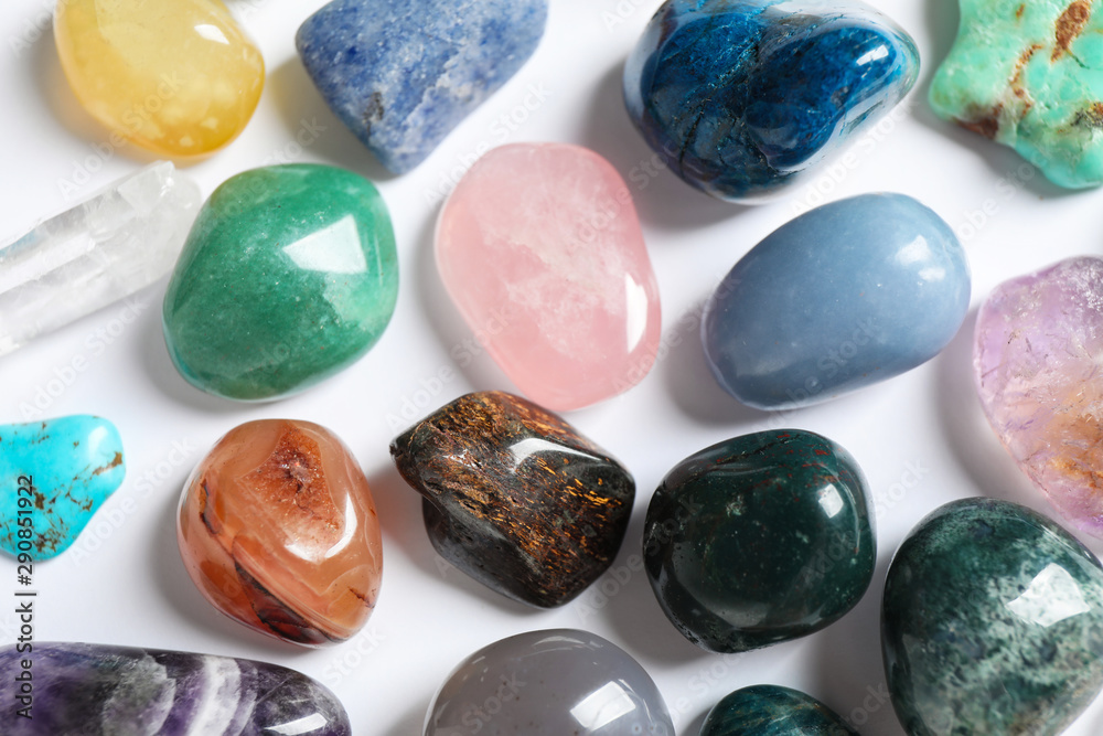 Different beautiful gemstones on white background, top view Different beautiful gemstones on white background, top view