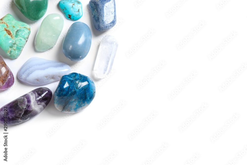 Different beautiful gemstones on white background, top view