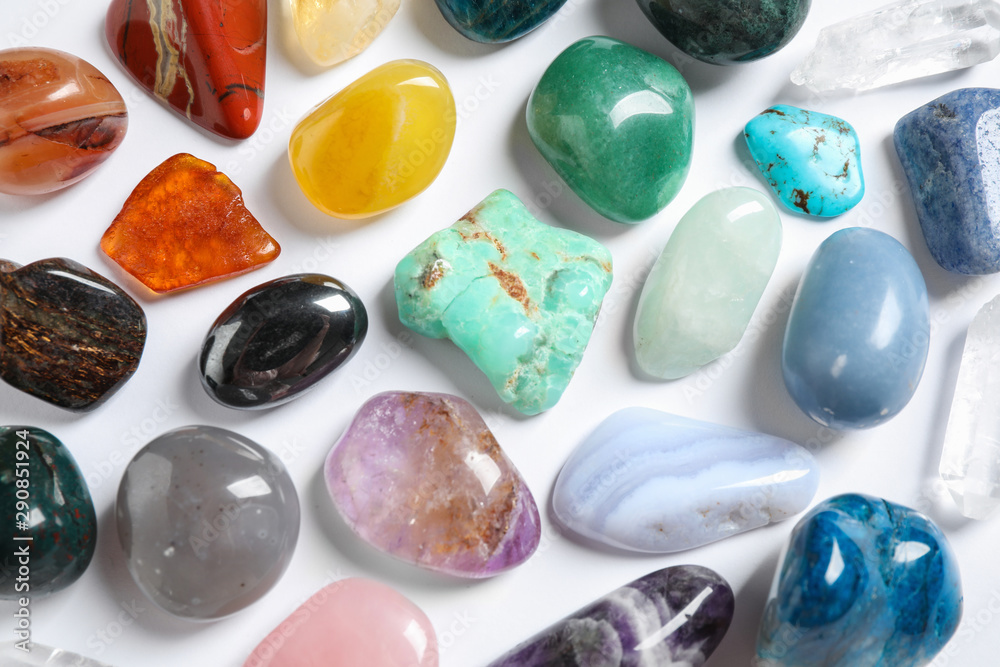 Different beautiful gemstones on white background, top view Different beautiful gemstones on white background, top view