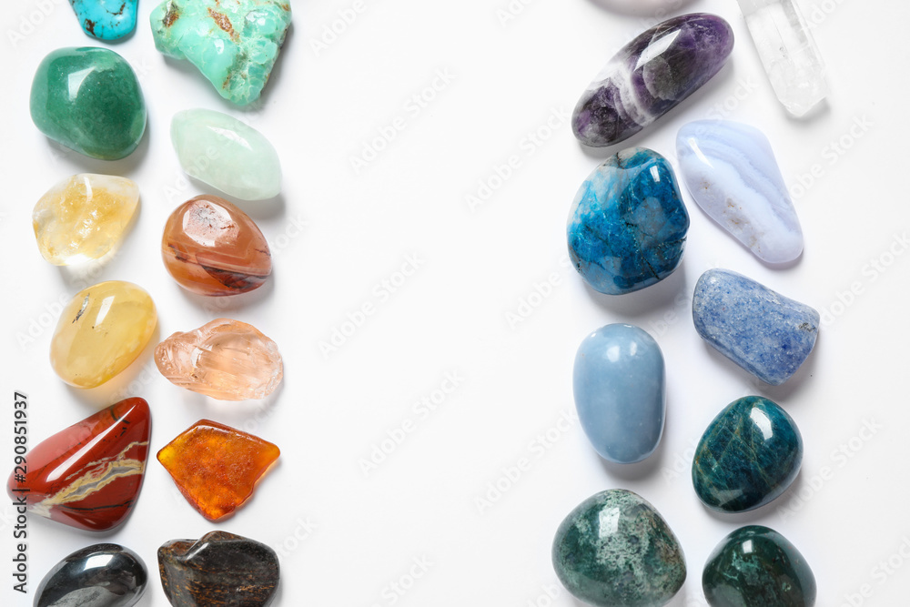 Frame made with different beautiful gemstones on white background, top view. Space for text Frame made with different beautiful gemstones on white background, top view. Space for text
