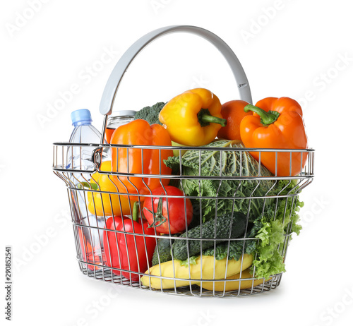 Shopping basket with grocery products on white background