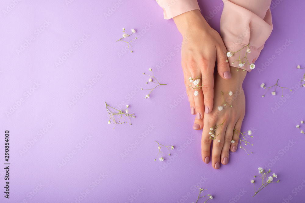 Fototapeta premium female well-groomed hands with white delicate flowers