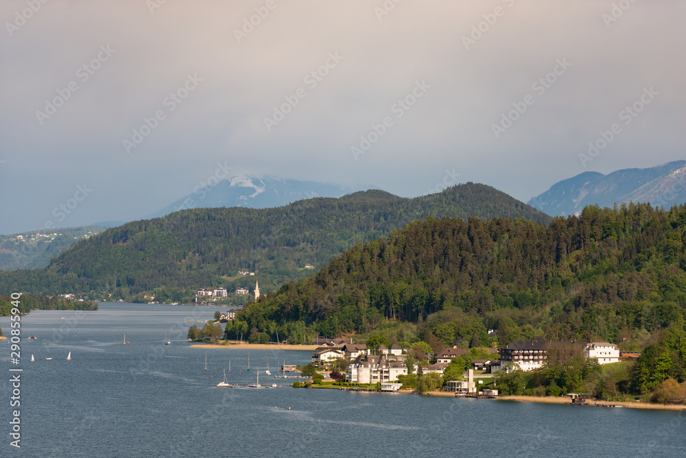 Austria. Lake Worthersee.  The village is in a picturesque location. Yachts on the clear surface of the lake.