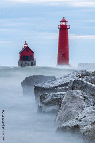lighthouse with rocks and fog