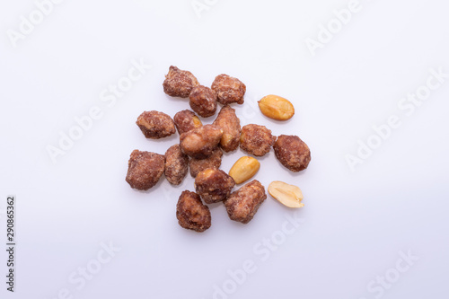 Peanuts praline sweet on dark grey background, top view, soft light, copy space