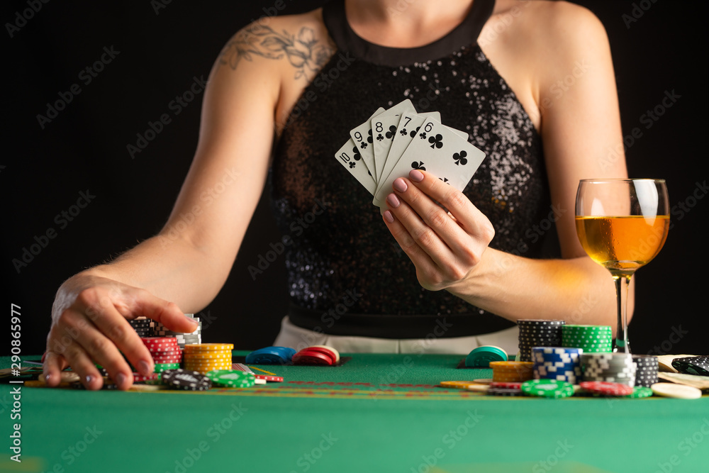 The girl won everything and takes all the chips, Playing in a casino, poker. Focus and focus on the chips. Raising bets, gaming business