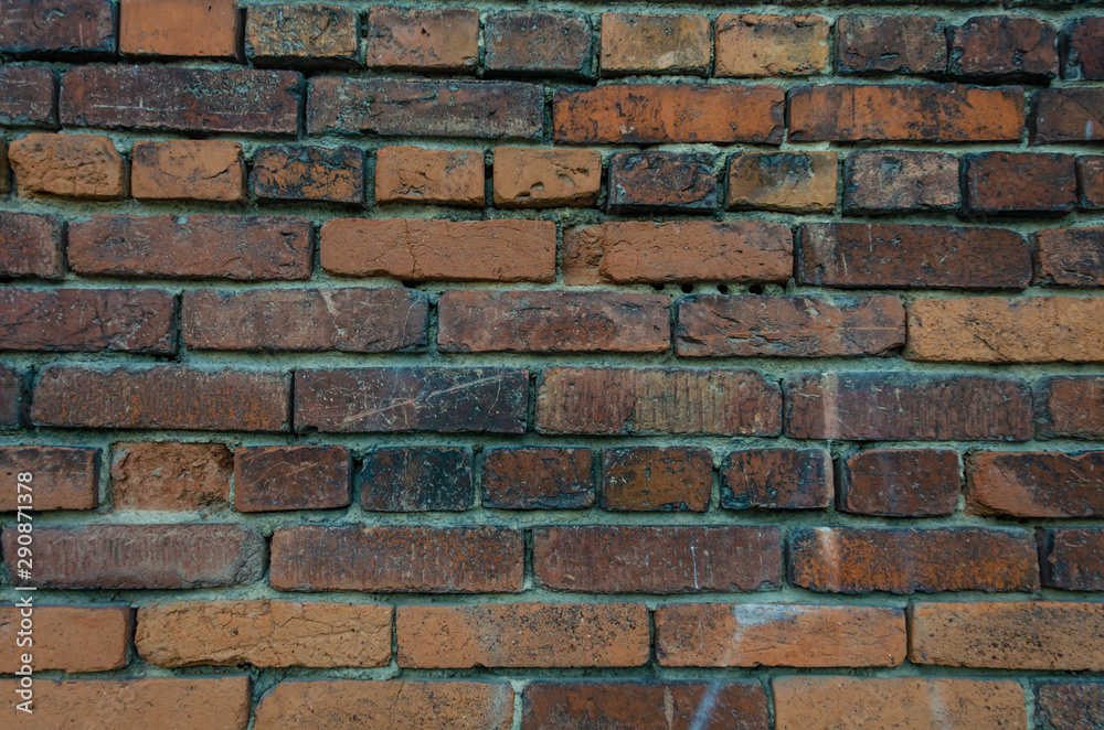 Fototapeta premium Old brick wall.Masonry of colored bricks.