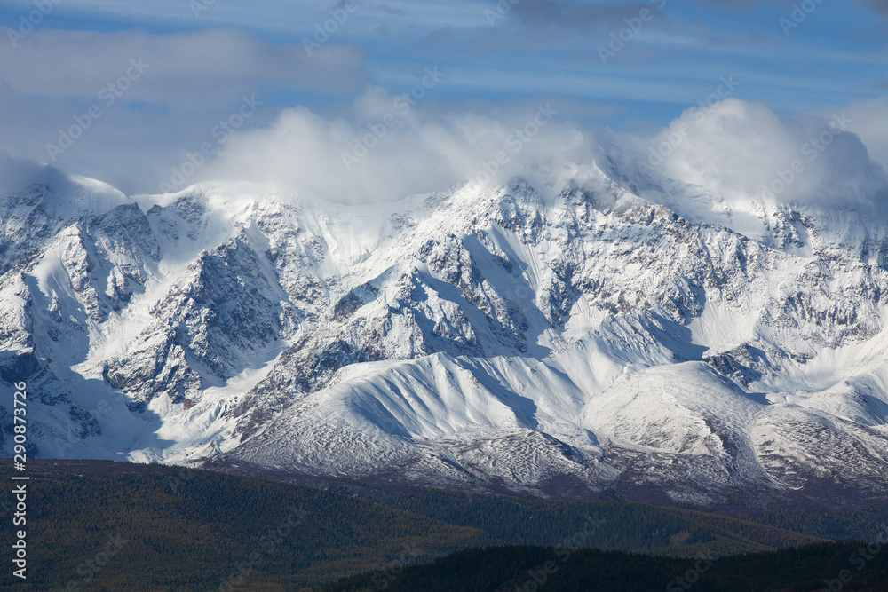 Fototapeta premium Snow-capped mountain peaks. Blue tint.
