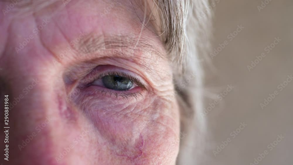 Close up of an elderly wrinkled face putting on a medical patient mask to prevent spreading a contagious disease or getting sick. Close up of an elderly wrinkled face putting on a medical patient mask to prevent spreading a contagious disease or getting sick.
