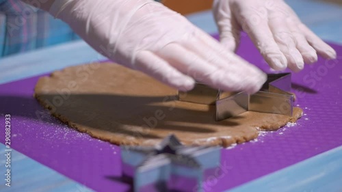 Woman Decorating Baked Gingerbread Christmas Cookies