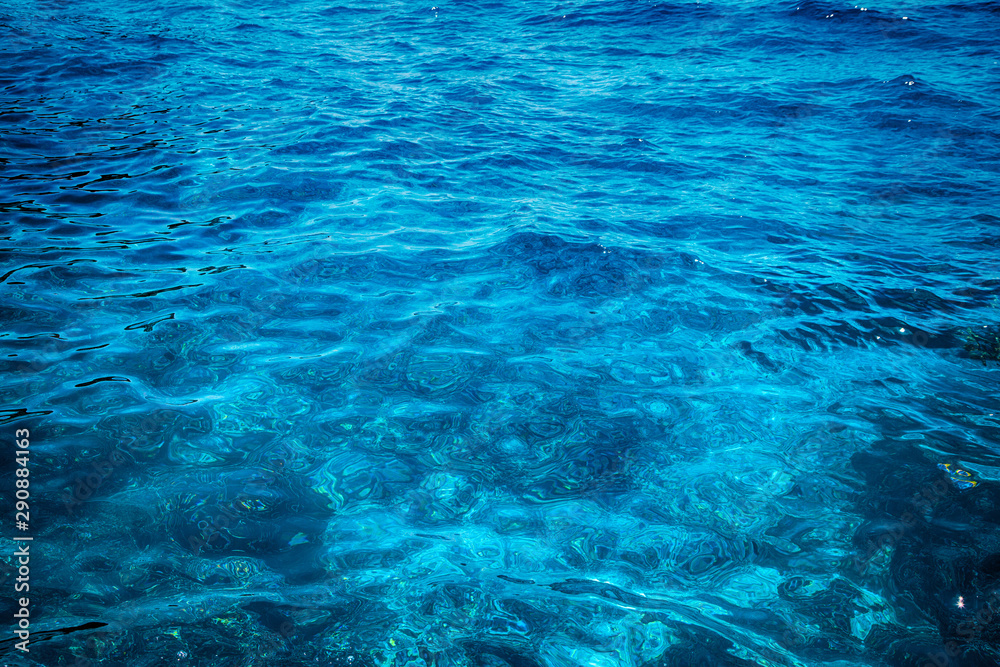 Blue clear water. Beautiful blue sea wave photograph close up. Beach vacation at sea or ocean.