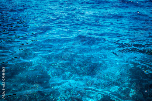 Blue clear water. Beautiful blue sea wave photograph close up. Beach vacation at sea or ocean.