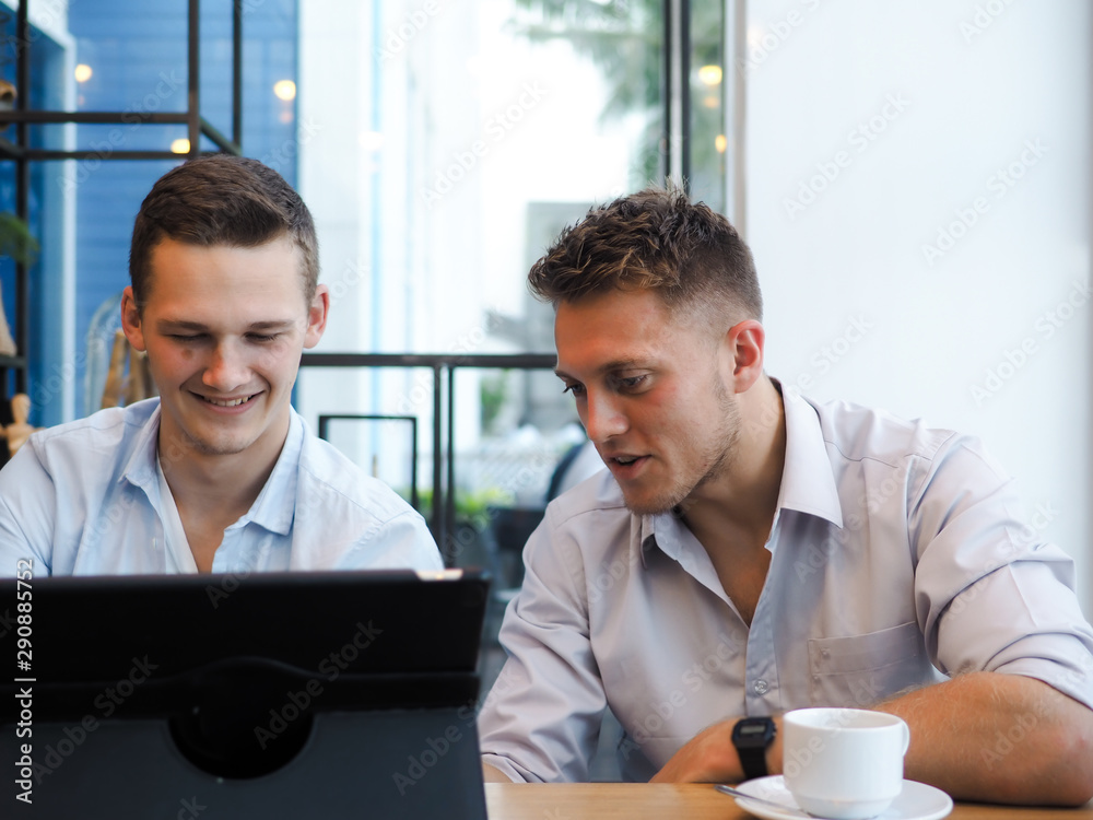 Smart men using tablet and drinking coffee in cafe, lifestyle concept. Smart men using tablet and drinking coffee in cafe, lifestyle concept.