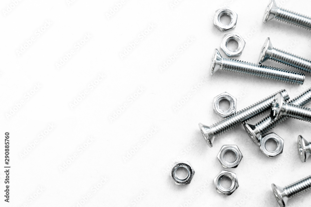 Top view of stainless steel bolts or iron nails on brigth white background with silver color. Metal screws for use in sheet metal. Top view of stainless steel bolts or iron nails on brigth white background with silver color. Metal screws for use in sheet metal.