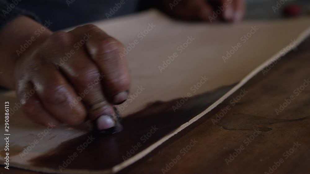 Artisan leather smith creating works of art in his studio Artisan leather smith creating works of art in his studio
