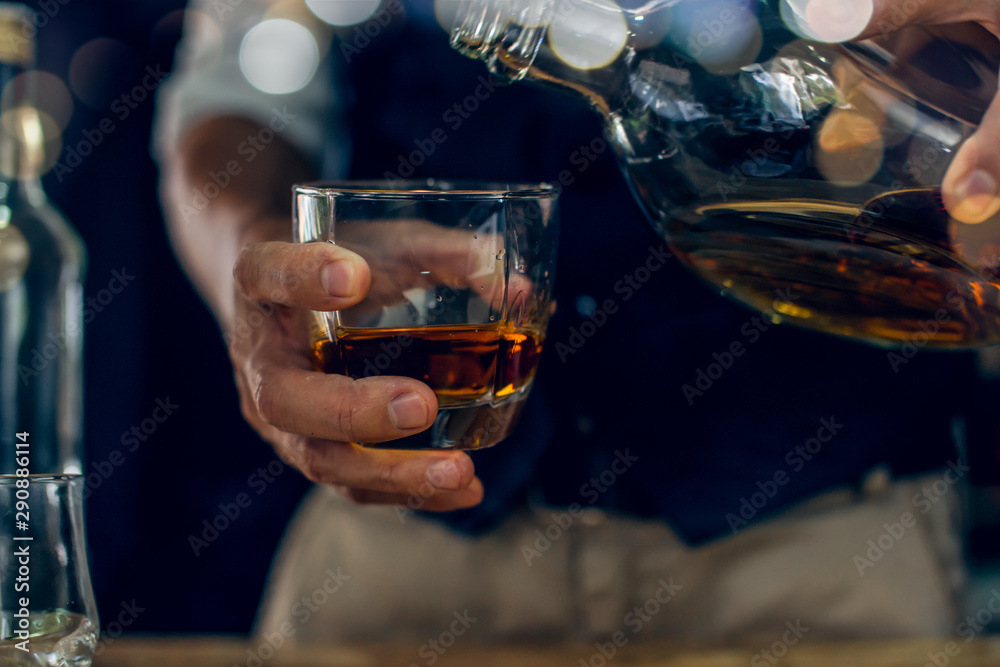 glass of brandy and cigar on a black background