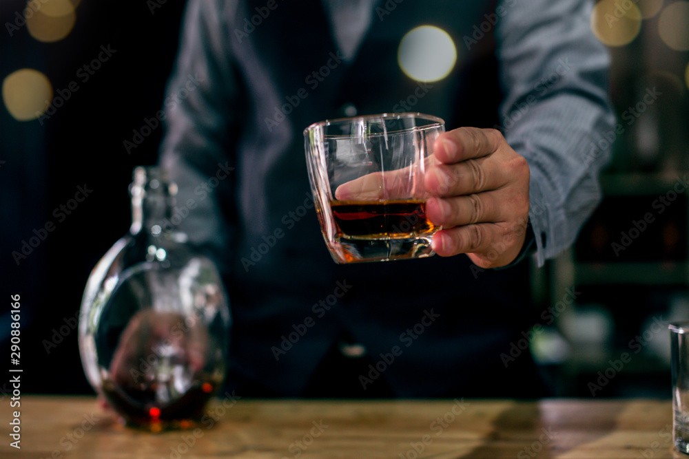 man holding glass of wine at restaurant