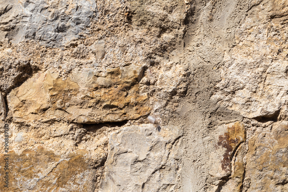 Natural background from a fragment of a stone wall of an old house Natural background from a fragment of a stone wall of an old house