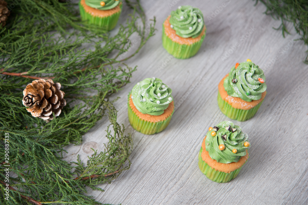 Green creamy topping with sugar bead on butter cup cake as for Christmas and Saint Patricks' Day and celebration